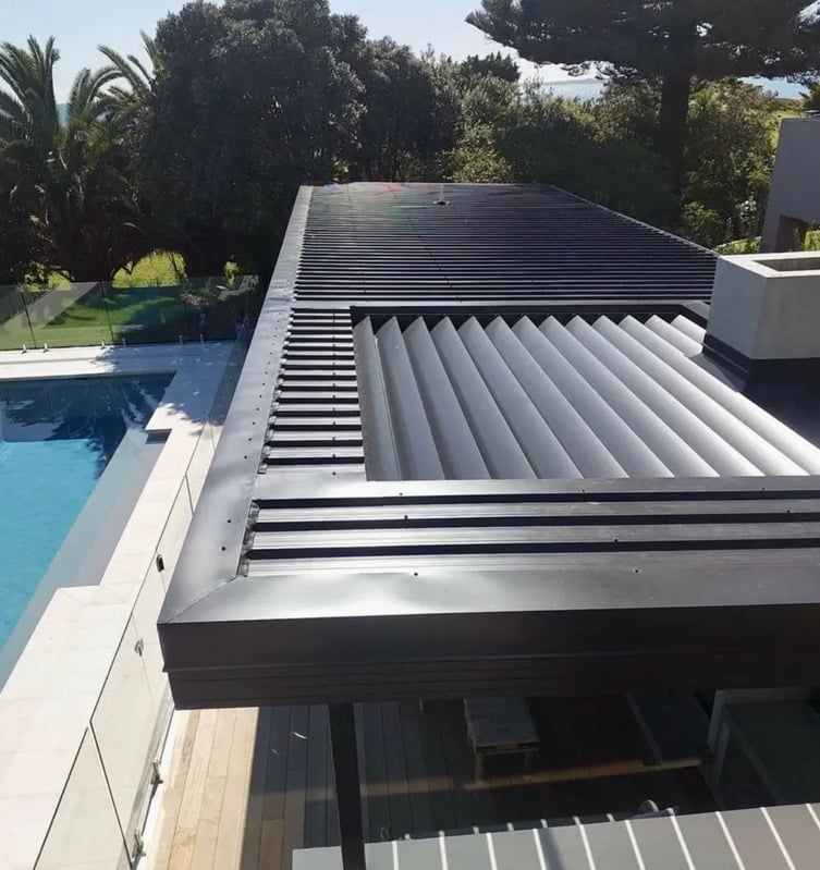 New metal patio roof beside a pool